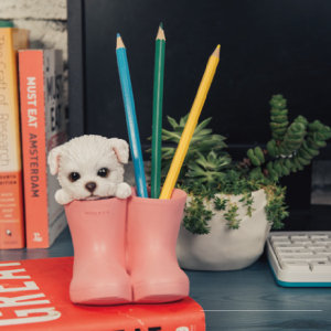 動物のペン立て｜ピンク色の長靴１足の片方に白い子犬が入っています。もう片方の長靴には３色の鉛筆が立てられていて、デスクを華やかに飾っています。